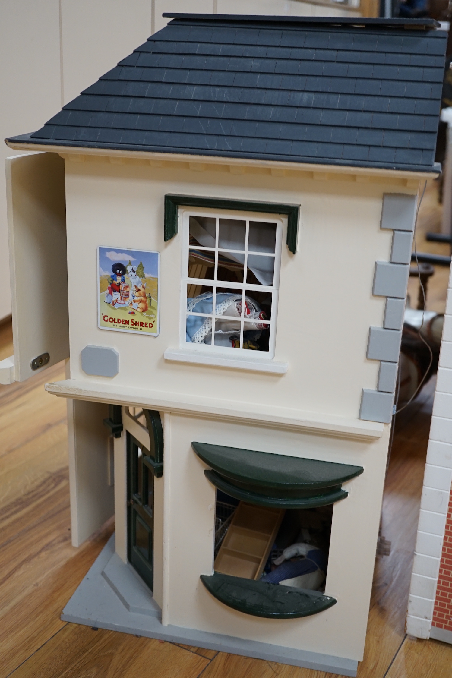 A modern Georgian style dolls house, with two front opening doors, containing six rooms with furnishings, figures, and electric lighting, together with a dolls shop, containing two rooms, furnishings, and accessories, et